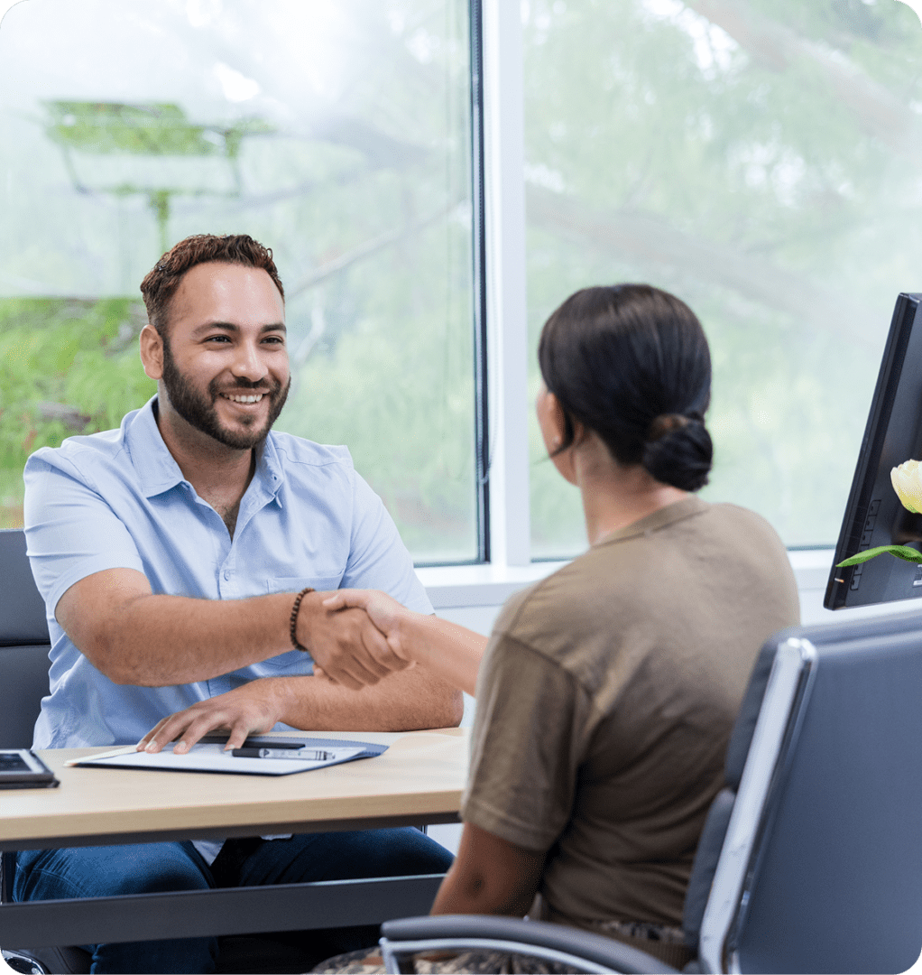 Professional handshake at a desk.