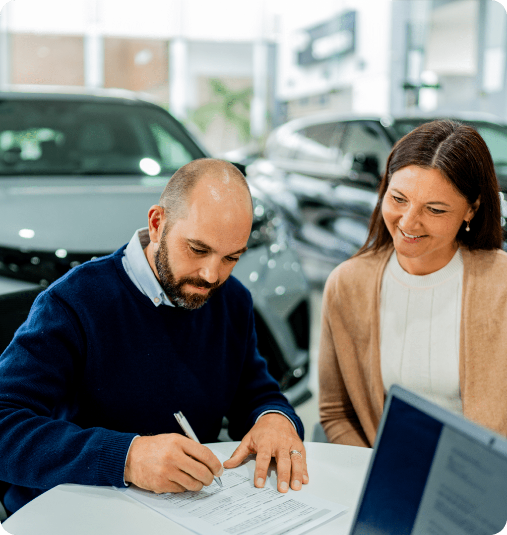 Man signing car purchase agreement